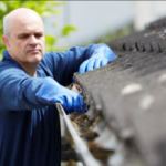 Man cleaning gutters