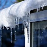 Ice in Gutters in the winter hanging on roof